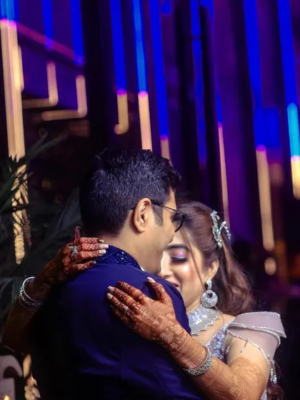 An intimate dance moment between the engaged couple, captured with a focus on their embrace.