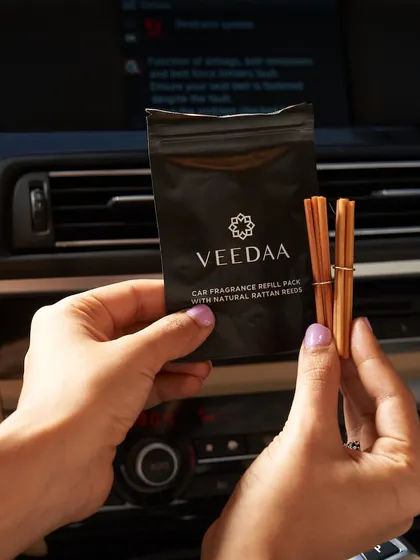 Preparing a car fragrance refill. The natural rattan reeds are free from the artificial chemicals, liquids, and gels found in many other car fresheners, offering a pure and natural scent.