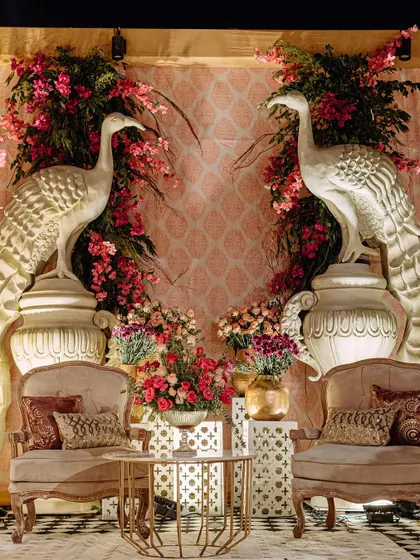 A beautiful photo corner with two peacock statues surrounded by a heart-shaped floral arrangement. This spot offers guests a perfect opportunity to capture memories.