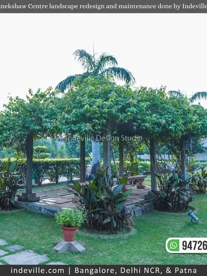 A beautiful tree-covered gazebo at Manekshaw Centre, providing a natural, shaded seating area within the vast gardens.