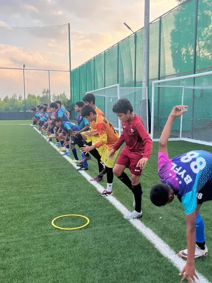 A player shows off his flexibility and balance during a dynamic warm-up.