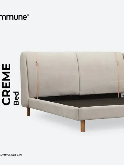 The Crème Bed, a beautiful example of Scandinavian-inspired design. The high, upholstered headboard with unique leather strap details provides a comfortable and stylish focal point for any modern bedroom.