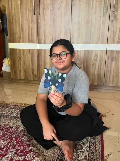 This artist is happy with the beautiful blue butterfly she created during our insect-themed class.