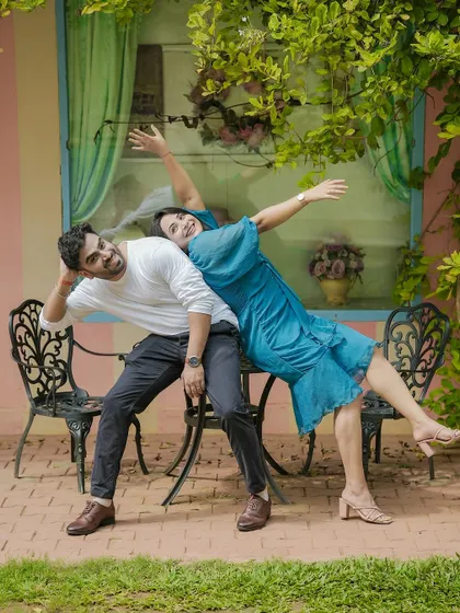 A hilarious and acrobatic pose with a couple in a garden, showcasing their fun and energetic personalities.