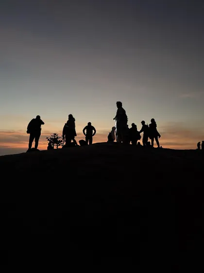 A silhouette of our group against the dawn sky at Uttari Betta, just before the sun appears.