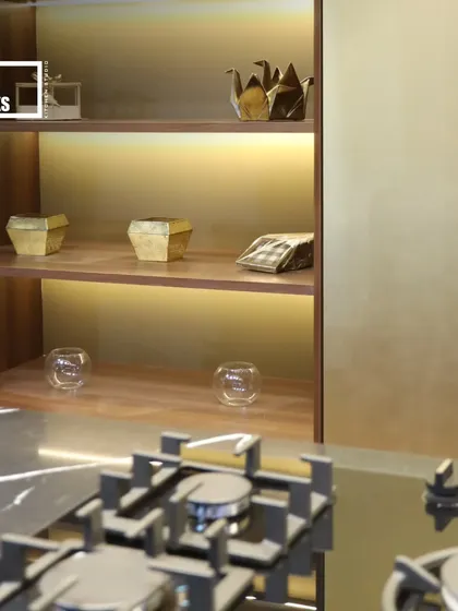 A close-up of back-lit open shelving next to the hob. This is a great way to display decorative items while adding a layer of ambient light to the kitchen.