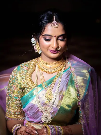 A vision in pastels. This bride chose a beautiful tissue silk saree in shades of lavender and seafoam green, paired with a heavily embellished blouse for her special day.