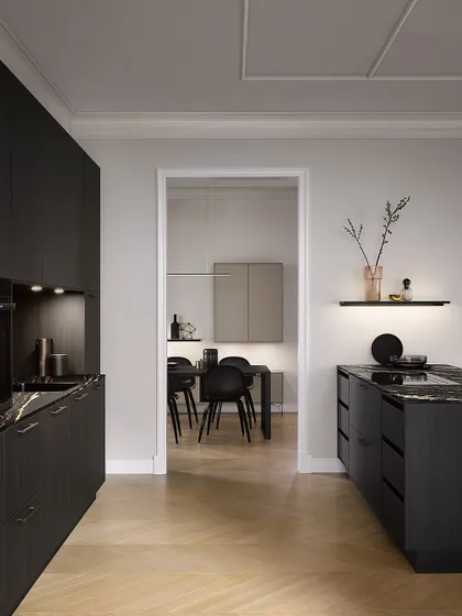 A view from the living area into the Black Fine Oak kitchen, showing how the dark, sophisticated design can be a stunning feature in an open-plan home.