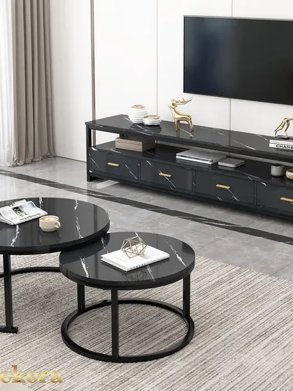 This black nesting coffee table set is shown here with a matching media console, creating a cohesive living room look. The black marble-effect tops and simple metal frames offer a sleek, modern aesthetic.