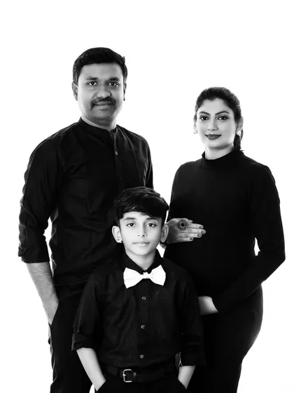 A black and white version of a modern family maternity portrait. This timeless edit emphasizes the emotion and connection within the family.