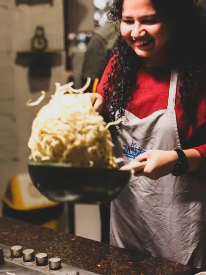 The joy of tossing noodles you've cooked yourself. This is a moment from our Chinese Cuisine Masterclass, where learning is always fun and interactive.