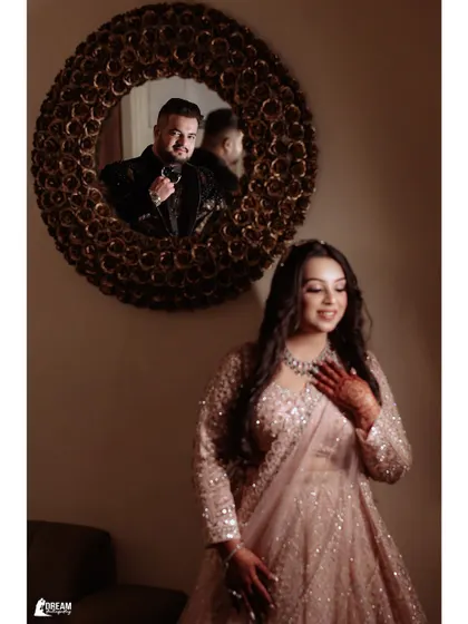 A creative portrait of Sarthak and Vanshika, with his reflection in the mirror looking towards her.