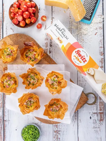 Savory filo cups for Switz, styled with fresh ingredients to suggest a recipe. This approach not only showcases the product but also inspires customers on how to use it, adding value beyond a simple product shot.