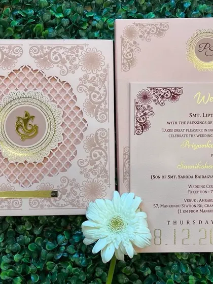A duplicate of ID 105, this pastel pink card with a laser-cut 'jaali' and glass Ganesha logo is a perfect blend of modern and traditional.