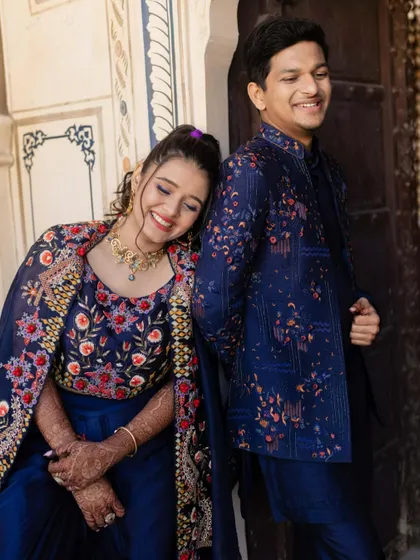 A sweet, candid moment of the bride resting her head on the groom's shoulder. Their relaxed and happy expressions speak of their comfort and love for each other.