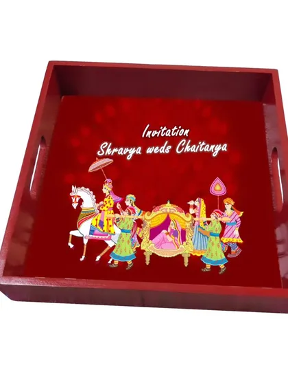We create customized invitation hamper trays with your choice of artwork, content, and fillers. This tray features a beautiful 'doli' scene with the couple's names.