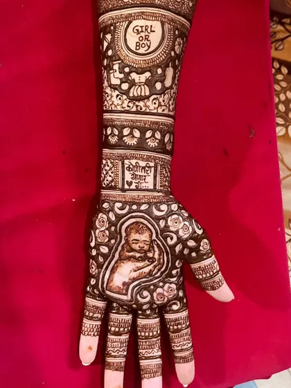 This design for a mom-to-be features a portrait of a sleeping baby on the palm. The arm includes a 'Girl or Boy' theme and a message in Marathi, 'Koni tari yenar aahe' (Someone is coming).