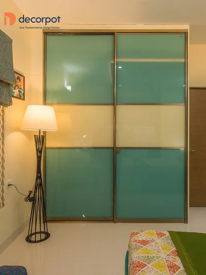 This two-door sliding wardrobe uses a color-blocking technique with sea-green and cream panels. It's a simple yet effective way to add a splash of color and personality to a bedroom.