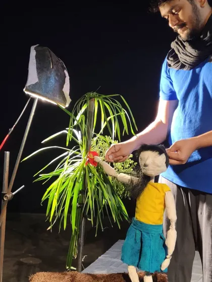 A glimpse into our creative process. Here, we are setting up a scene with simple props and focused lighting.