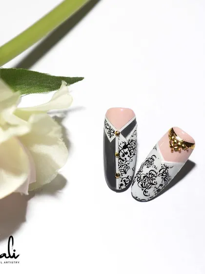 A fun 'bride and groom' nail art concept, using stamping and gold studs to create a tuxedo and gown design.