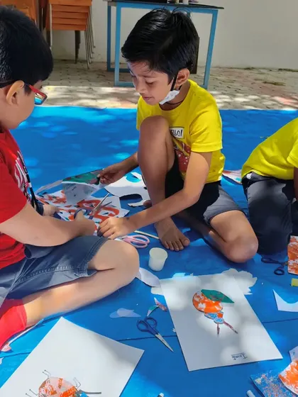 Two boys collaborating on their bug art. It's great to see them sharing ideas and working together during a creative session.