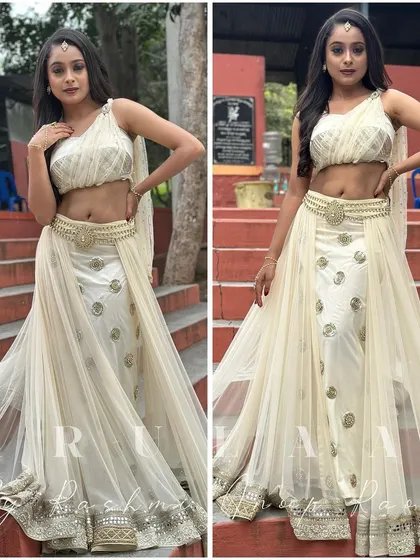 The final look of the white and gold ensemble for Kamini in 'Nooru Janmakoo'. The outfit features a flowing net dupatta and intricate gold embroidery, creating a look that is both angelic and dramatic.