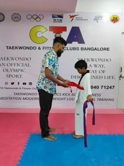 Tying a red belt.
