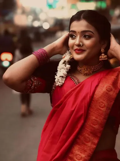 Even in a busy street setting, the elegance of a traditional half saree stands out. This is a testament to its timeless appeal.