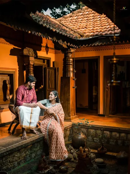 A beautifully composed shot of a couple in the courtyard of a traditional home, with the warm lighting creating a romantic and timeless atmosphere.