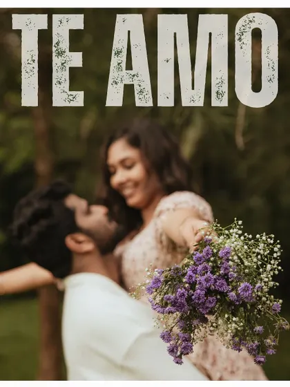 A creative and romantic pre-wedding shot with a bouquet of flowers in the foreground, and the word "Te Amo."