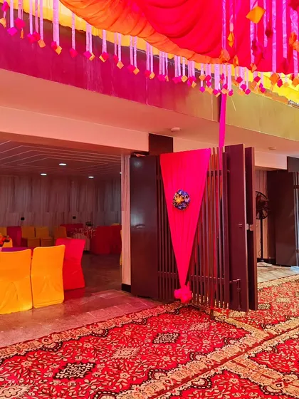 The entrance to an indoor hall from an outdoor decorated area. I use fabric draping and floral accents to connect the different spaces and maintain a consistent theme.