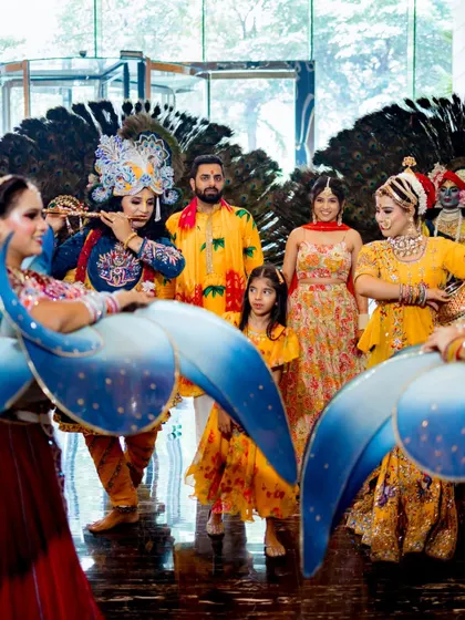 The couple surrounded by dancers in traditional attire, adding a cultural and festive element to their Haldi.