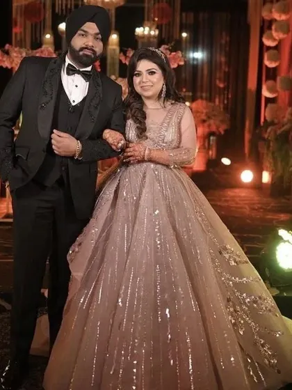 This couple looks picture-perfect in their reception attire. I can create a similar embellished princess gown for her and a classic tuxedo for him.