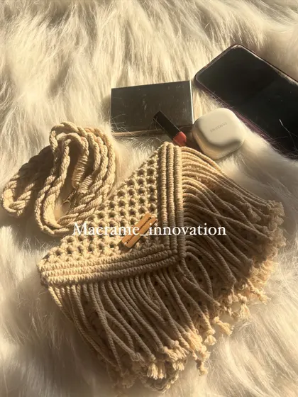 Another look at the beige macrame sling bag, showing off the beautiful fringe and the texture of the knots.