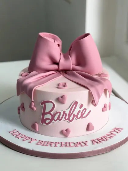 Pretty in pink and topped with a dreamy bow, this Barbie-themed birthday cake is pure perfection for every doll-loving heart. It's all about glam, sweetness, and pink magic.