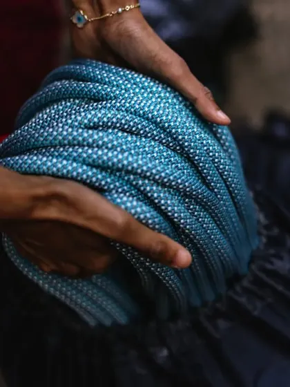 Coiling a Petzl Mambo rope. We teach proper rope care and management, an essential skill for any aspiring sport climber.