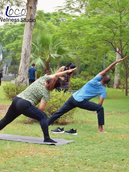 The extended side angle pose, demonstrated here by two clients in our park yoga session, is fantastic for stretching the entire side of the body and building strength in the legs.