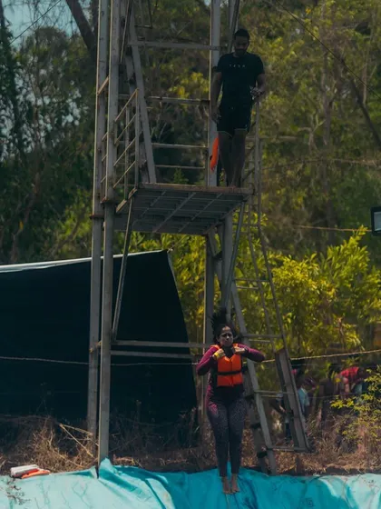 Wearing a life vest, a participant takes her first jump during the safety clinic. We provide gear and guidance to make sure everyone feels secure.