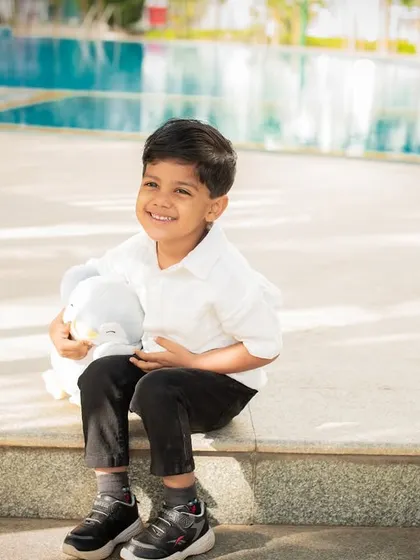 A happy moment by the pool. Outdoor locations provide beautiful backdrops for kids' and family portraits.
