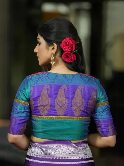 A back view of our dual-tone blouse in teal and purple, showcasing the beautiful paisley motif.