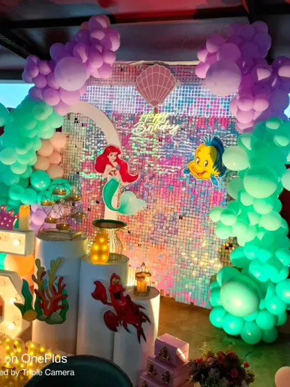 A different take on The Little Mermaid theme, this time for a 5th birthday. The setup includes Flounder and Sebastian, with balloon arrangements that look like ocean coral.