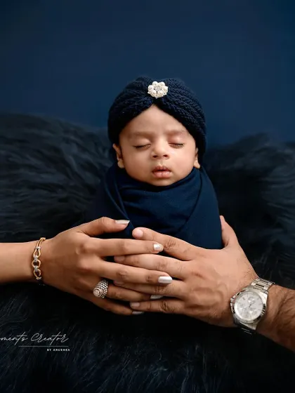 A tiny prince held safely in his parents' hands. This iconic newborn portrait captures the overwhelming love and protection that surrounds a new baby. It's a simple, powerful image that families will treasure forever.