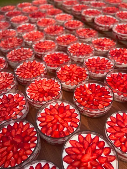 Layers of happiness, delivered. This is a large order of our Strawberry & Cream Cheese Trifles, each cup topped with beautifully arranged fresh strawberries. The vibrant red makes for a stunning visual.