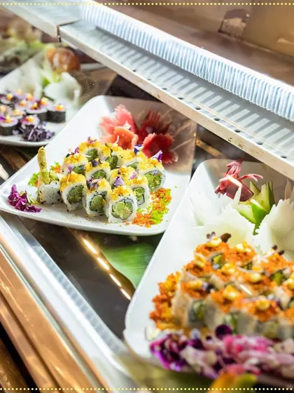A glimpse into our live sushi bar display. We offer a wide variety of rolls, from classic California to inventive vegetarian options, all beautifully garnished and ready to be enjoyed.