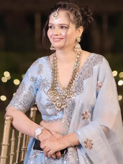 A close-up of her happy expression and the beautiful details of her jewelry.