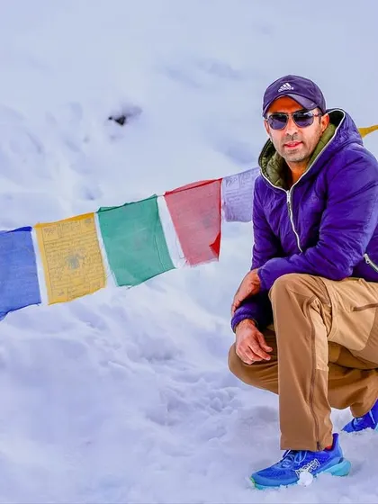 Taking a moment to soak it all in at Khardungla Pass. The combination of snow, sun, and prayer flags creates a truly spiritual and energizing atmosphere.