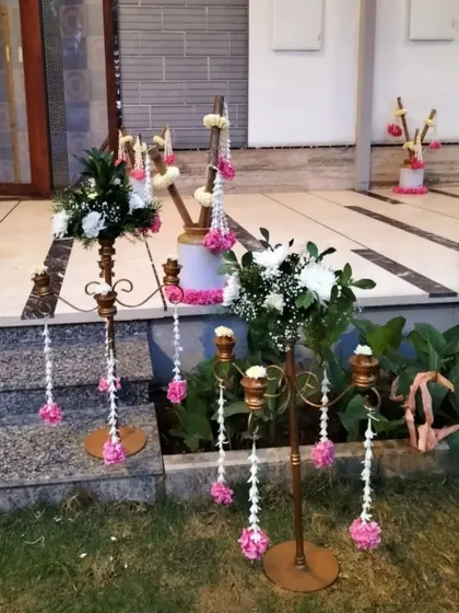 Another view of the floral candelabras, showcasing how they can be used to line a pathway or decorate a space with elegance.