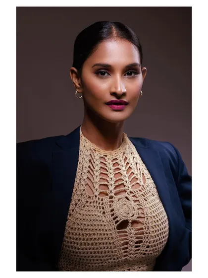 A confident and professional portrait of a model. The blazer and direct gaze create a powerful and modern look.