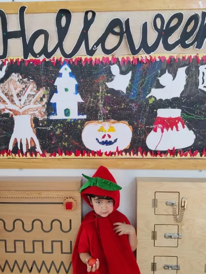 Little Red Riding Hood poses in front of our Halloween art display. The children's costumes are always wonderfully creative and add to the festive atmosphere.