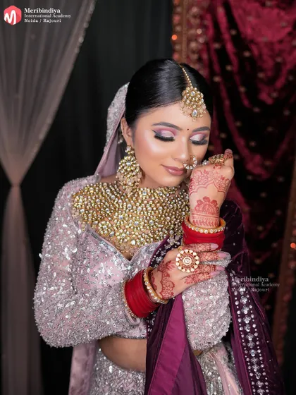 This image highlights the complete bridal profile, with a sleek bun that provides a perfect base for the dupatta and heavy jewelry.
